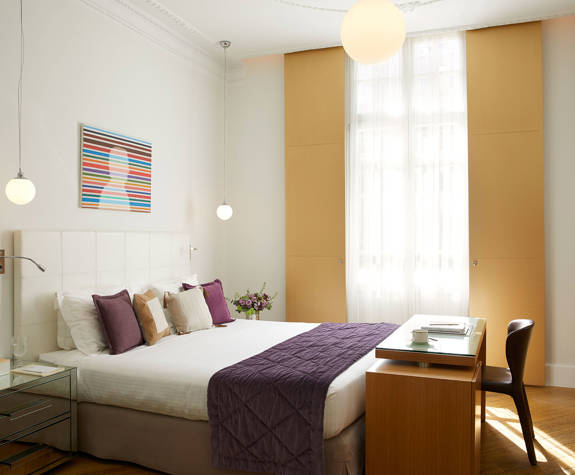 The Excelsior Hotel Deluxe Room double bed and amenities