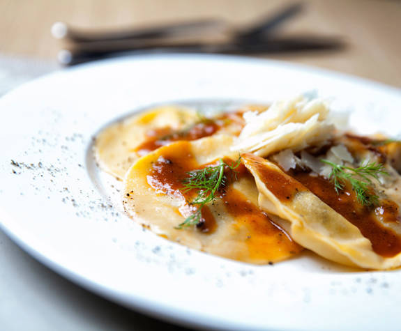Gourmet ravioli pasta with tomato sauce at Clochard restaurant in Excelsior Hotel