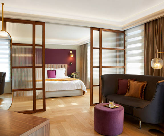 The Excelsior Hotel Penthouse Suite living room and bedroom in the background